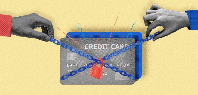 two hands locking a metal chain around a credit card