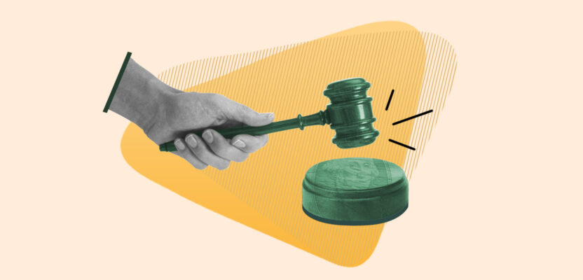 Hand pounding gavel representing a court judgment