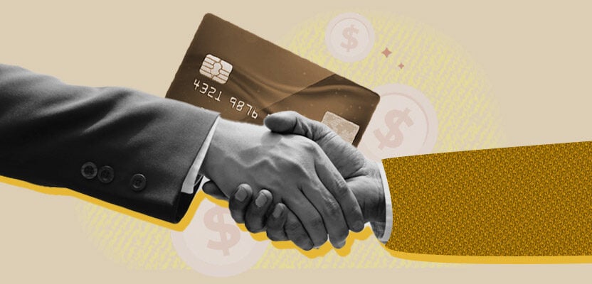 Handshake in front of a credit card representing negotiating credit card debt