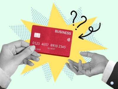 Hand receiving a business credit card