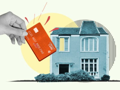 Credit card being inserted into house representing paying rent with a card