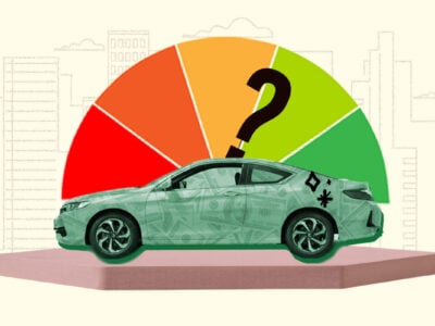 Car sitting in front of credit score gauge