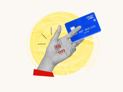 Hand with PIN written on it holding a credit card