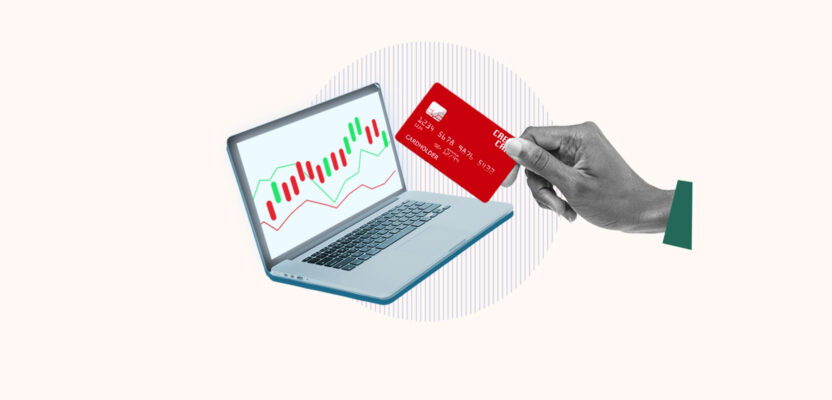 Computer showing stock being bought with a credit card