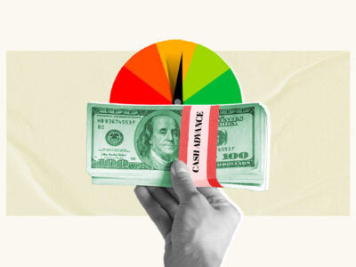 Money from cash advance being held in front of credit score gauge